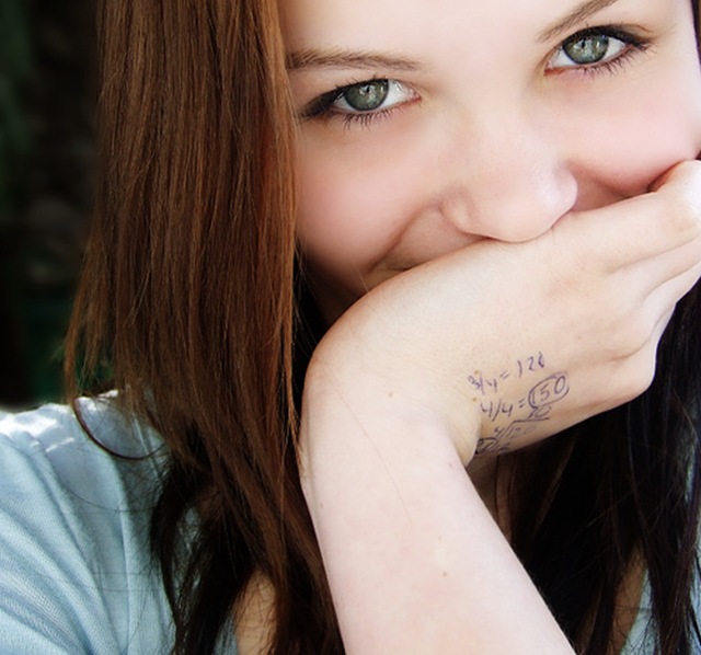 girl with calculations scribbled on hand